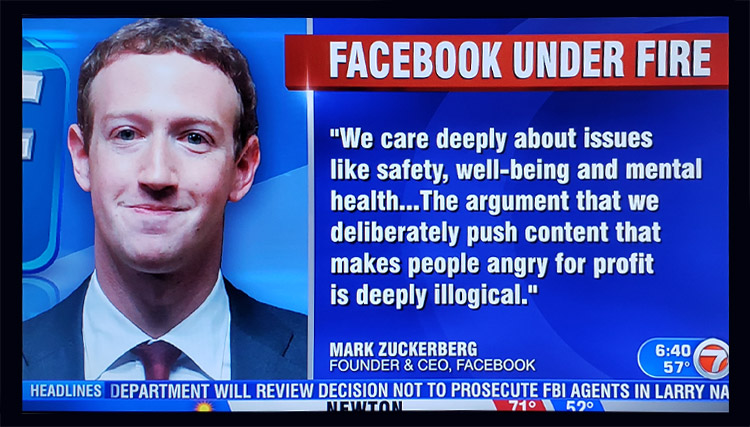 Image showing a screen grab of a news headline showing Mark Zuckerberg, and the headline reading, "Facebook under fire".